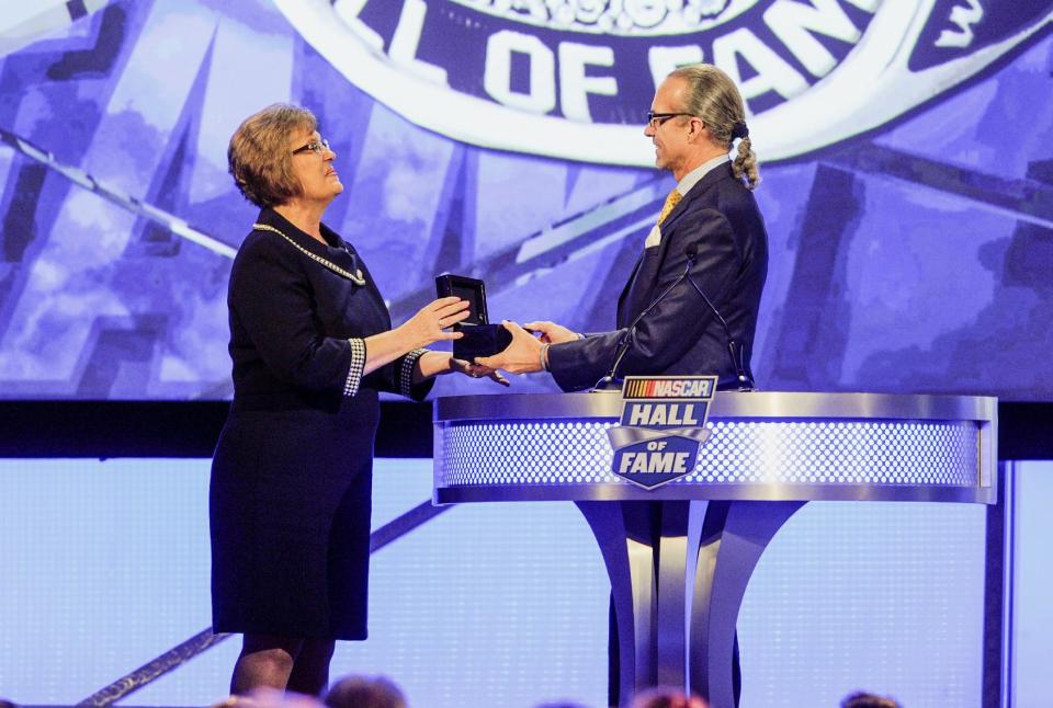 Former driver Kyle Petty presents the NASCAR Hall of Fame ring to a granddaughter of Raymond Parks, Patricia DePottey, during the NASCAR Hall of Fame induction ceremony in Charlotte, N.C., Friday, Jan. 20, 2017. (AP Photo/Mike McCarn)