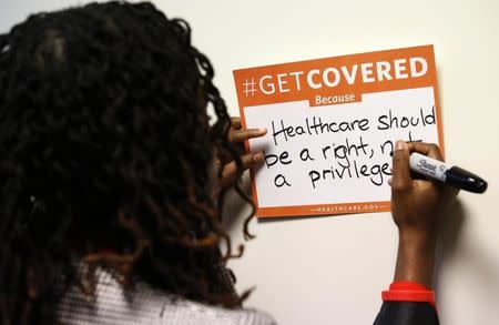 A woman fills out her thoughts on the Affordable Care Act at the White House Youth Summit on the Affordable Care Act in Washington December 4, 2013. REUTERS/Kevin Lamarque