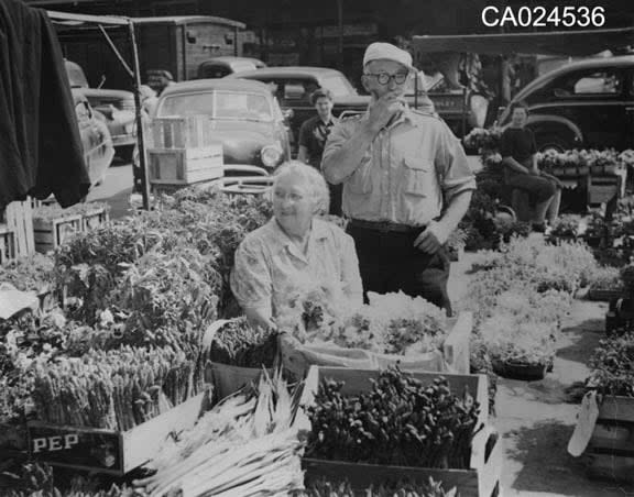 A photo believed to be from the 1950s or 1960s shows members of the Schinzel family at their stand at the Parkdale Market in Ottawa.