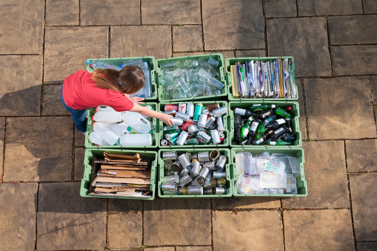Girl organizing recycling bins Getty Images/Jacobs Stock Photography Ltd