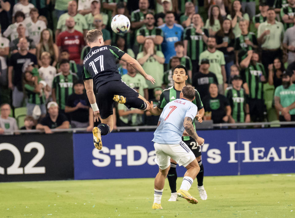 Austin FC defender Jon Gallagher (17) heads the ball against FC Dallas midfielder Paul Arriola (7) during the first half of an MLS playoff soccer match, Sunday, Oct. 23, 2022, in Austin, Texas. (AP Photo/Michael Thomas)