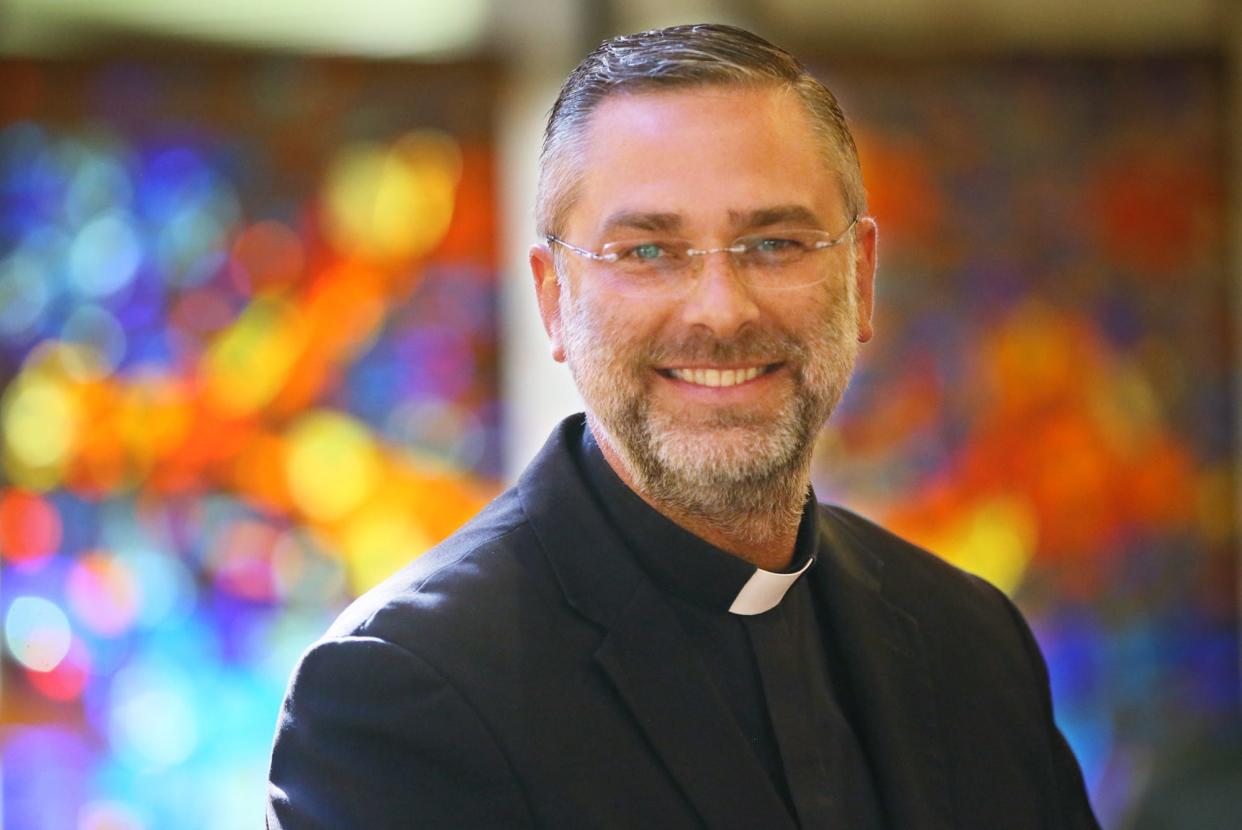 Rev. Shawn Conoboy talks about his assignment to the Vatican while in the sanctuary of Our Lady of Perpetual Help Catholic Church in Aurora on Friday.  Rev. Conoboy will work on the staff of  Dicastery for Promoting Integral Human Development.