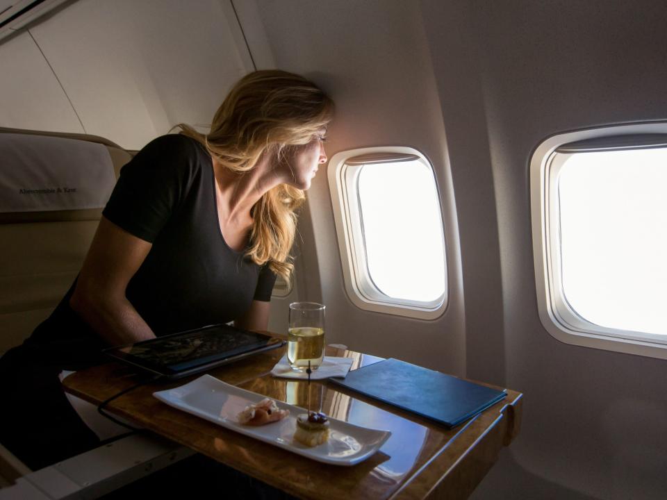 A person staring out the airplane window.