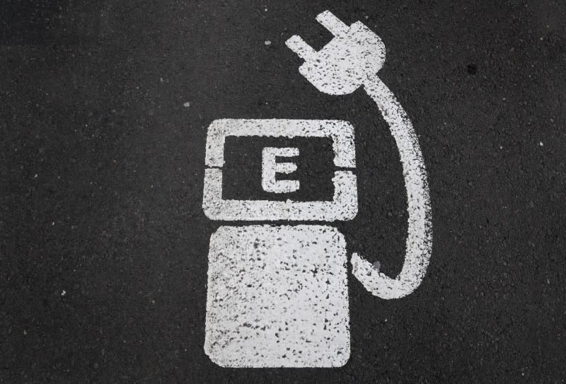 A battery charger sign for electric cars is painted on the ground of a parking ground near the soccer stadium in Wolfsburg