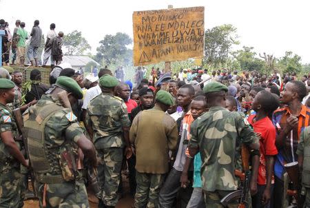 Residents block a road as they protest the killings of two locals earlier in the morning, claiming the crimes were committed by members of the United Nations Organization Mission in the Democratic Republic of the Congo (MONUC) and the Congolese army, in Beni in North Kivu province October 22, 2014. REUTERS/Kenny Katombe