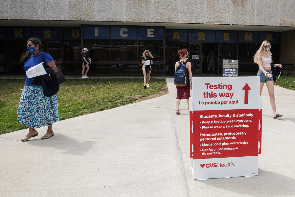 FILE - In this April 8, 2021, file photo, students exit the KSU Ice Arena after getting their Johnson & Johnson COVID-19 vaccination at Kent State University in Kent, Ohio. Even as restrictions relax across much of the United States, colleges and universities have taken new steps to police campus life as the virus spreads through students who are among the last adults to get access to vaccines. (AP Photo/Phil Long, File)