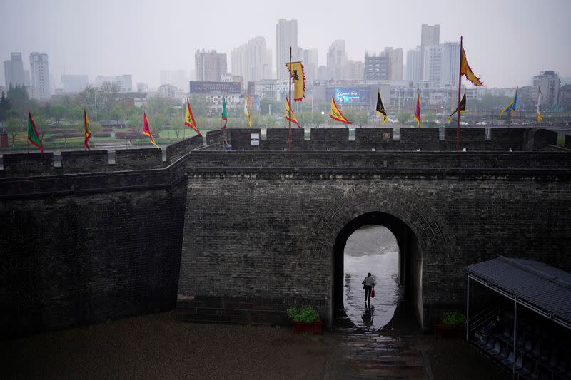 A man walks through an ancient city wall in Jingzhou, after the lockdown was eased in Hubei province