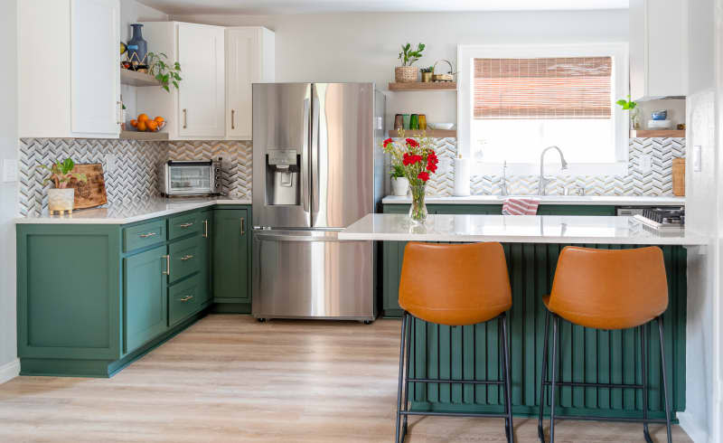 Kitchen with green cabinets, light wood floor, and white countertops