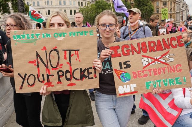 Extinction Rebellion protesters hold up placards