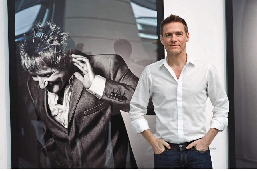 Bryan Adams with one of his portraits of Rod Stewart.