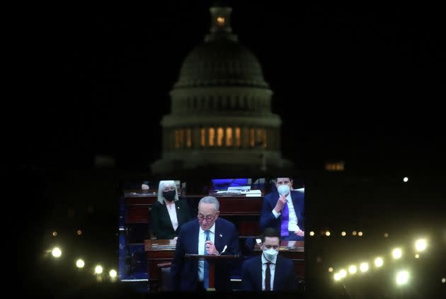 Senate Majority Leader Chuck Schumer (D-N.Y.) is projected live on a screen as he takes part in the debate from senators of voting rights legislation, on Jan. 19.  (Photo: Leah Millis via Reuters)