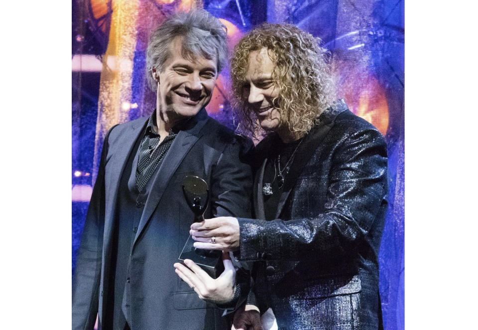 FILE - This April 14, 2018 file photo shows Jon Bon Jovi, left, and David Bryan of the band Bon Jovi at the 2018 Rock and Roll Hall of Fame Induction Ceremony in Cleveland, Ohio. Bryan, the keyboardist for Bon Jovi is embarking on a busy 2020, with a new album and tour with one of America's favorite rock bands as well as opening his second Broadway musical, “Diana.” (Photo by Michael Zorn/Invision/AP, File)