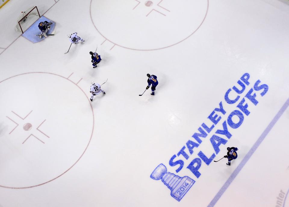 Chicago Blackhawks' Patrick Kane (88) scores past St. Louis Blues goalie Ryan Miller, top left, during the first period in Game 1 of a first-round NHL hockey Stanley Cup playoff series Thursday, April 17, 2014, in St. Louis. (AP Photo/Jeff Roberson)