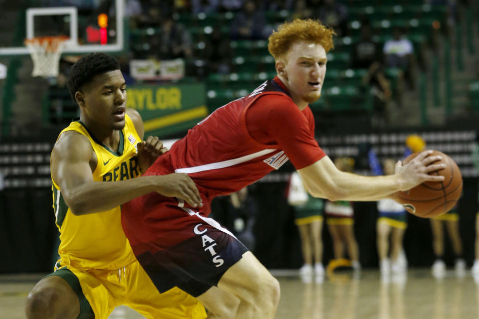 Baylor guard Jared Butler (12) defends as Arizona guard Nico Mannion (1) looks for space during the first half of an NCAA college basketball game in Waco, Texas, Saturday, Dec. 7, 2019. (AP Photo/Michael Ainsworth)