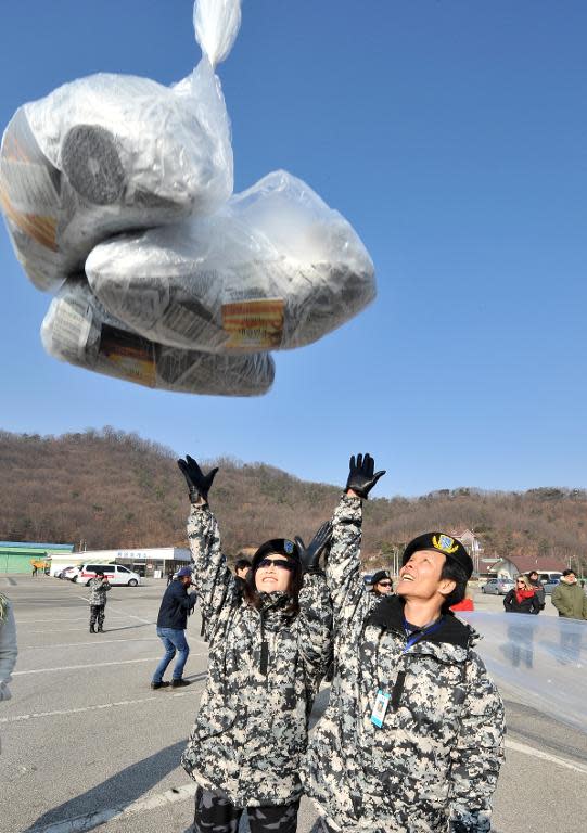 Former North Korean defectors release balloons carrying anti-North Korea leaflets at a park in the border town of Paju, north of Seoul, on January 15, 2014