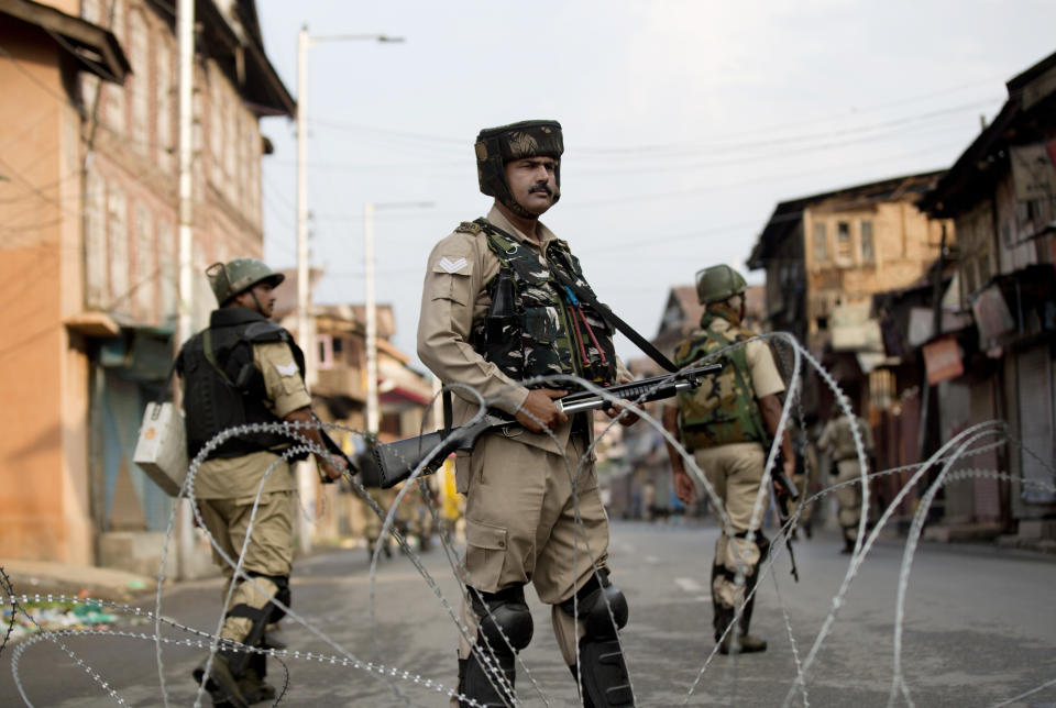 Indian Paramilitary soldiers stand guard during curfew in Srinagar, Indian controlled Kashmir, Wednesday, Aug. 7, 2019. Authorities in Hindu-majority India clamped a complete shutdown on Kashmir as they scrapped the Muslim-majority state's special status, including exclusive hereditary rights and a separate constitution, and divided it into two territories. (AP Photo/Dar Yasin)