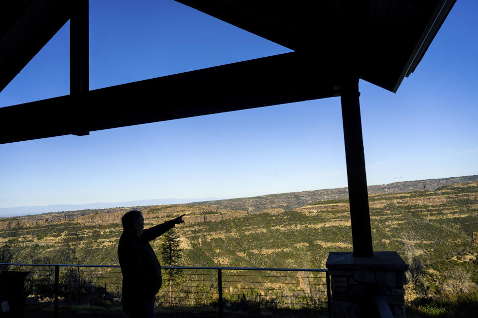 Paradise Mayor Greg Bolin looks out over Butte Creek Canyon from his back deck, Thursday, Oct. 26, 2023, in Paradise, Calif. Bolin, who lost his home in the 2018 Camp Fire, rebuilt on a different parcel with a similar view. (AP Photo/Noah Berger)