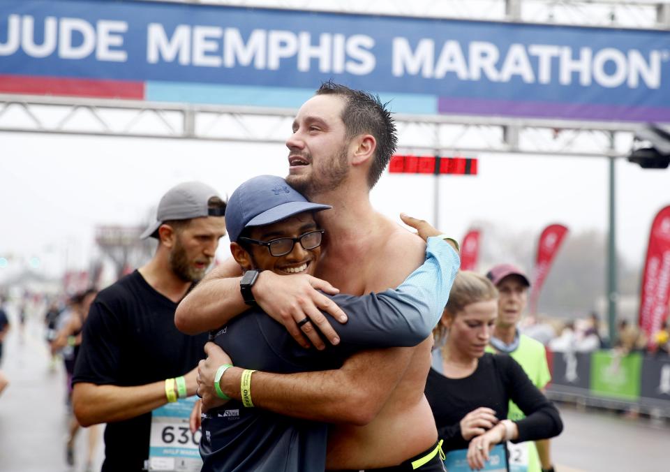 Tyler Fennema, from Horn Lake, hugs an unidentified man after completing the 2021 St. Jude Memphis Half Marathon on Saturday, Dec. 4, 2021 in Downtown Memphis.  