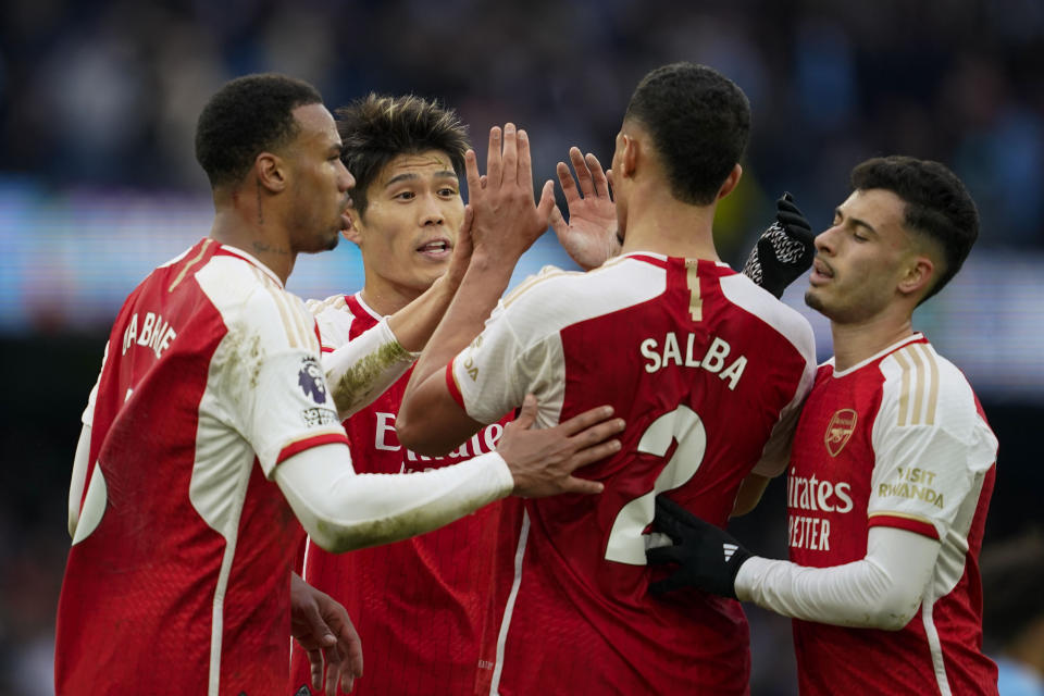 Arsenal celebrate at the end of the English Premier League soccer match between Manchester City and Arsenal at the Etihad stadium in Manchester, England, Sunday, March 31, 2024. (AP Photo/Dave Thompson)