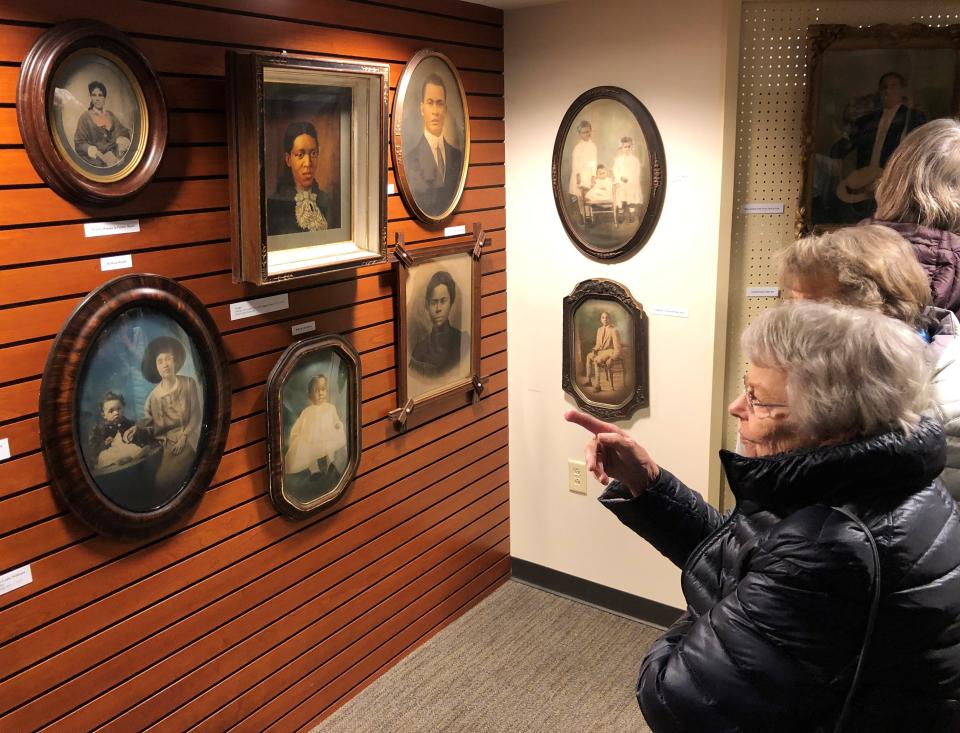 Visitors enjoy the collection of African American portraits of Connie Fredericks-Malone and her husband, James Malone. The exhibit runs through February at Wood Library in Canandaigua.