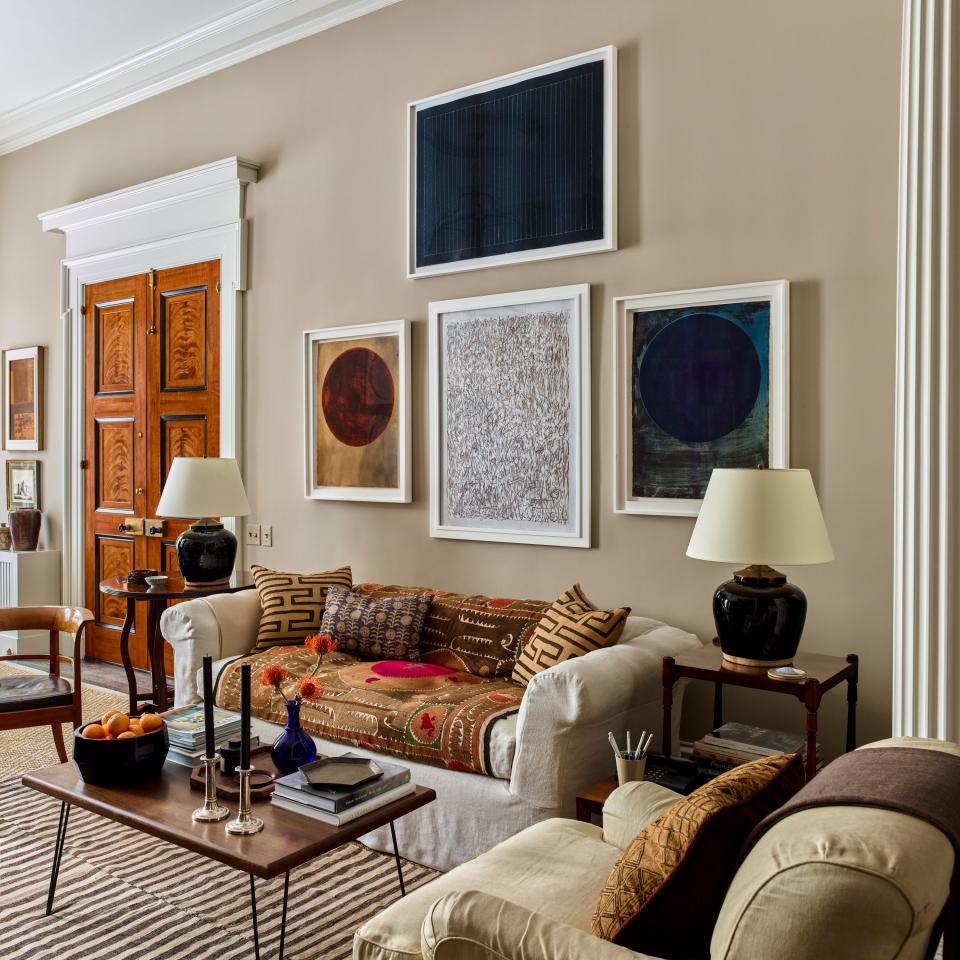 Architect Gil Schafer worked with his firm’s interior design team to gently reimagine his Greenwich Village pied-à-terre with an eye to modernity. In the living room, a suzani sourced on a trip to Morocco enlivens the neutral-hued sofa, which is slipcovered in linen from Arabel Fabrics and flanked by a pair of lamps from Sutter Antiques. Artwork by Harrison Walker and Corey Daniels line the walls, and the custom cocktail table was fabricated by Baba Wood.