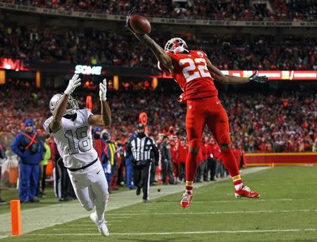 Dec 8, 2016; Kansas City, MO, USA; Kansas City Chiefs cornerback Marcus Peters (22) breaks up a pass intended for Oakland Raiders wide receiver Andre Holmes (18) during the second half at Arrowhead Stadium. The Chiefs won 21-13. Mandatory Credit: Jay Biggerstaff-USA TODAY Sports