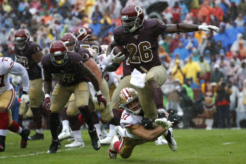 Washington Redskins running back Adrian Peterson (26) rushes against San Francisco 49ers defensive end Nick Bosa (97) in the first half of an NFL football game, Sunday, Oct. 20, 2019, in Landover, Md. (AP Photo/Alex Brandon)