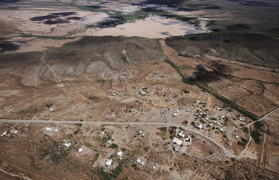 The earthen Menagers Dam that was in imminent danger of failing, potentially sending floodwaters rushing into the Tohono O'odham village of Ali Chuk, has held steady as the lake behind it receded Wednesday, Oct. 3, 2018, southwest of Sells, Ariz. Evacuations had begun Tuesday night after Hurricane Rosa's remnants drenched the western half of Arizona. (Mike Christy/Arizona Daily Star via AP)