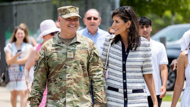 PHOTO: Republican presidential candidate Nikki Haley walks with her husband Maj. Michael Haley following a deployment ceremony for his unit of the South Carolina National Guard on June 17, 2023, at Johnson Hagood Stadium in Charleston, S.C. (Mic Smith/AP)