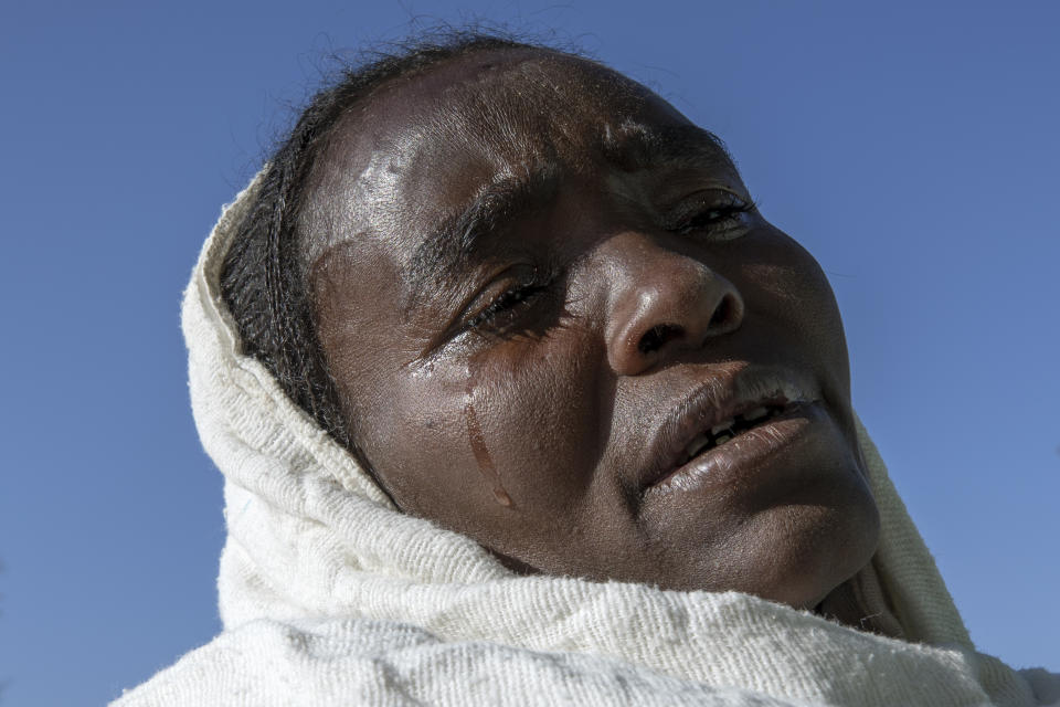 A Tigrayan woman who fled the conflict in Ethiopia's Tigray region, weeps after Sunday Mass ends at a church, near Umm Rakouba refugee camp in Qadarif, eastern Sudan, Nov. 29, 2020. (AP Photo/Nariman El-Mofty)