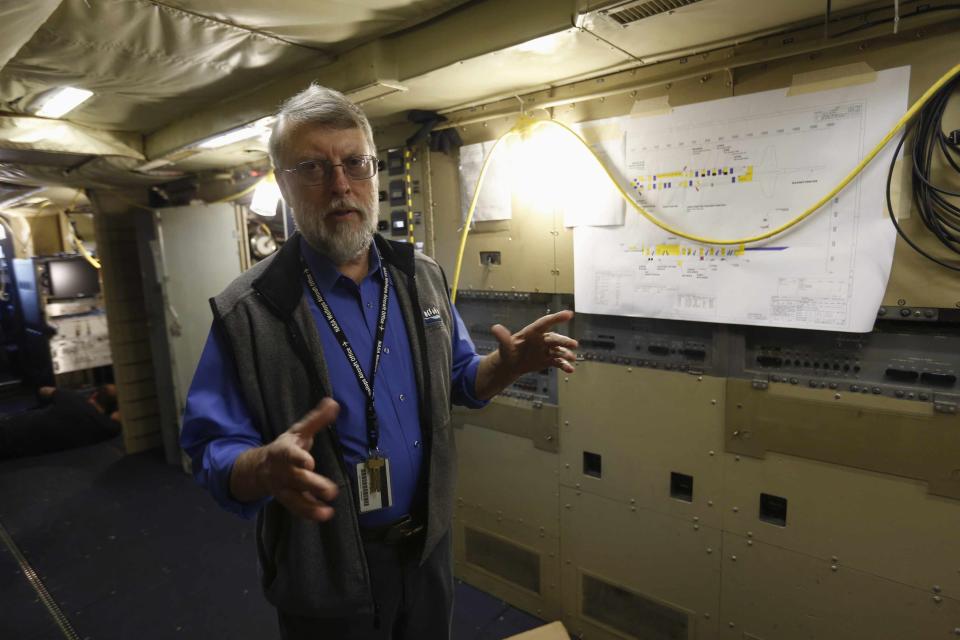 NASA scientist William Krabill talks while on board a NASA P-3 plane at the NASA Wallops flight facility on Wallops Island, Virginia