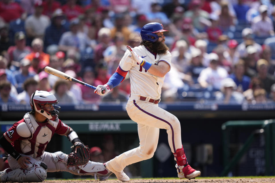 Philadelphia Phillies' Brandon Marsh follows through after hitting a two-run single against Arizona Diamondbacks relief pitcher Kevin Ginkel during the sixth inning of a baseball game, Wednesday, May 24, 2023, in Philadelphia. (AP Photo/Matt Slocum)