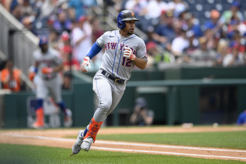 New York Mets' Francisco Lindor runs to first with a single during the third inning of the first baseball game of a doubleheader against the Washington Nationals, Saturday, June 19, 2021, in Washington. This is a makeup of a postponed game from April 1. (AP Photo/Nick Wass)