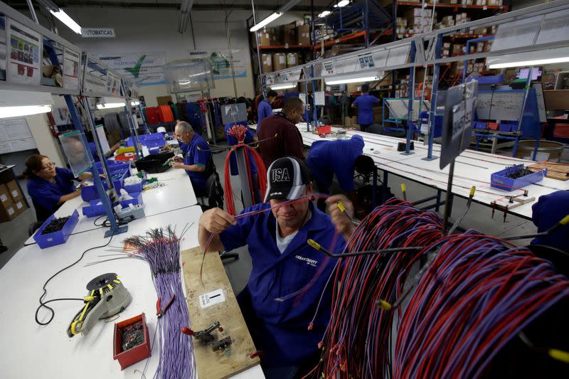 FILE PHOTO: Employees work at a wire harness and cable assembly manufacturing company that exports to the U.S., in Ciudad Juarez