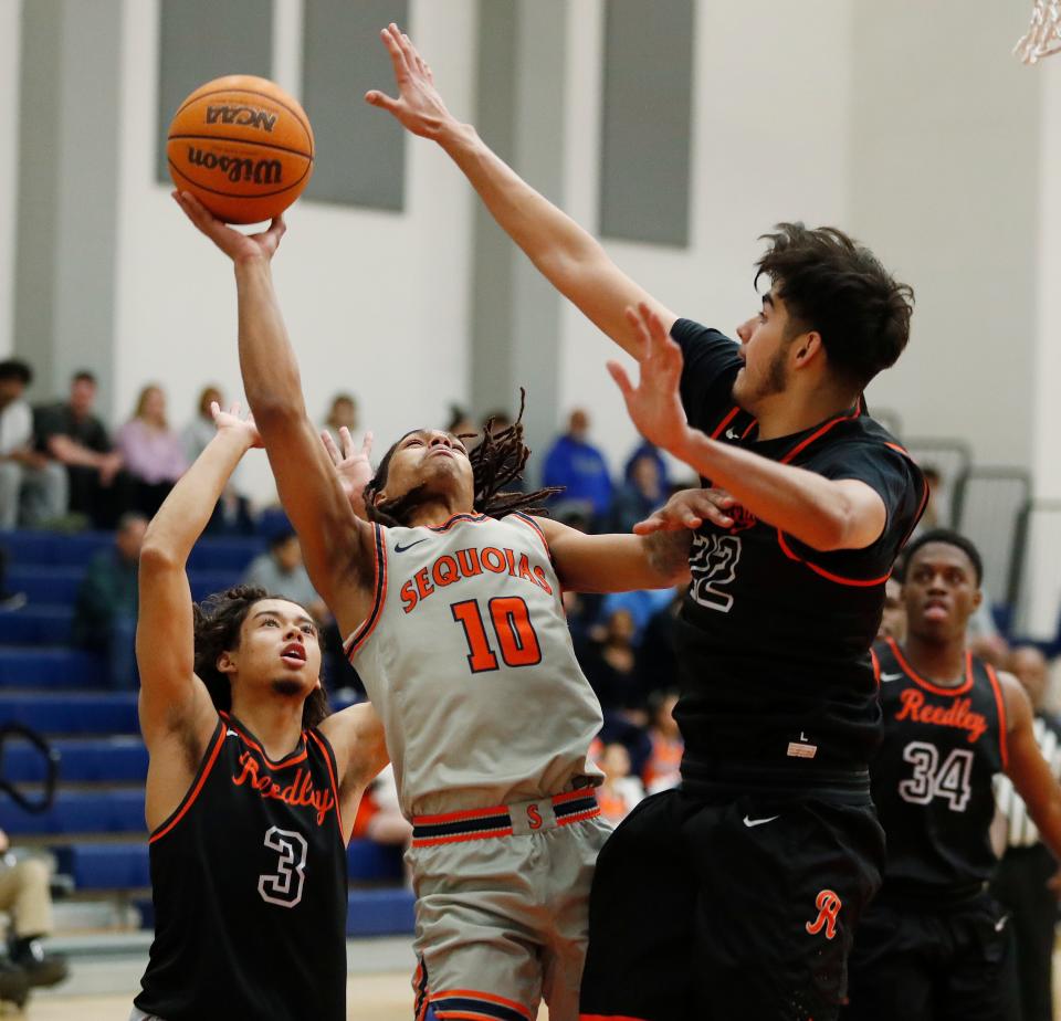 College of Sequoia's Jose Cuello goes up strong against Reedley College during their Central Valley Conference junior college menÕs basketball game on Wednesday, Jan. 31, 2024.