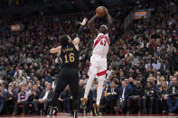 Toronto Raptors' Pascal Siakam (43) scores on Cleveland Cavaliers' Cedi Osman during the first half of an NBA basketball game in Toronto, Monday, Nov. 28, 2022. (Chris Young/The Canadian Press via AP)