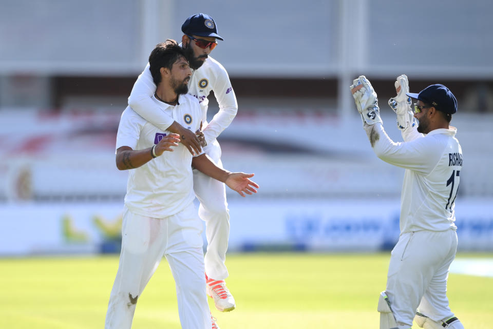 LONDON, ENGLAND - AUGUST 14: India bowler Ishant Sharma celebrates with team mates after taking the wicket of Sam Curran during day three of the Second Test Match between England and  India at Lord's Cricket Ground on August 14, 2021 in London, England. (Photo by Stu Forster/Getty Images)