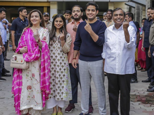 <p>Dhiraj Singh/Bloomberg/Getty</p> Mukesh Ambani and Nita Ambani with their sons Akash Ambani and Anant Ambani, and daughter Isha Ambani at a polling station during the fourth phase of voting for national elections in Mumbai, India, on Monday, April 29, 2019.