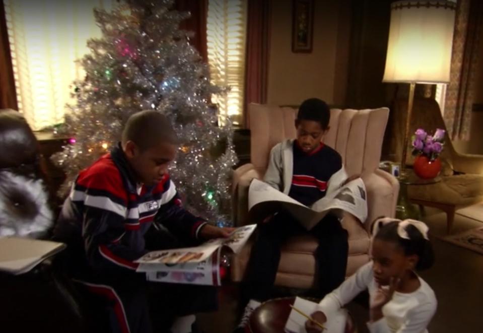 Characters Chris, Drew and Tonya gather by the Christmas tree in "Everybody Hates Chris"
