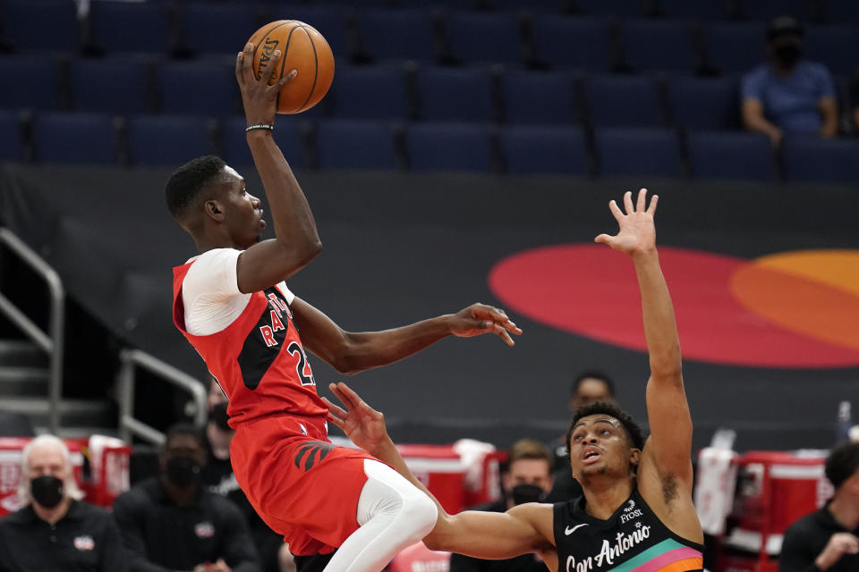 Toronto Raptors forward Chris Boucher (25) shoots over San Antonio Spurs forward Keldon Johnson (3) during the first half of an NBA basketball game Wednesday, April 14, 2021, in Tampa, Fla. (AP Photo/Chris O'Meara)