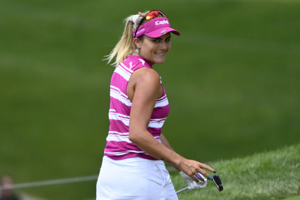 Lexi Thompson smiles after her putt on the 15th green during the third round in the Women's PGA Championship golf tournament at Congressional Country Club, Saturday, June 25, 2022, in Bethesda, Md. (AP Photo/Terrance Williams)