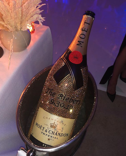 Personalised, and bejewelled champagne was on the menu for guests of the happy couple. Photo: Instagram/kyliejenner