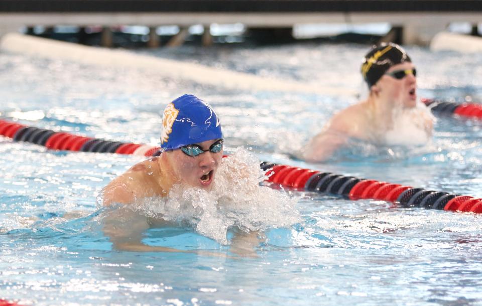 Lucas Byrd of Elkhart competes in the 100 Yard Breaststroke during the NIC Boys Swimming Finals Saturday, Jan. 28, 2023 at the Elkhart Aquatics Center. Behind him is Collin Fleming of Penn.