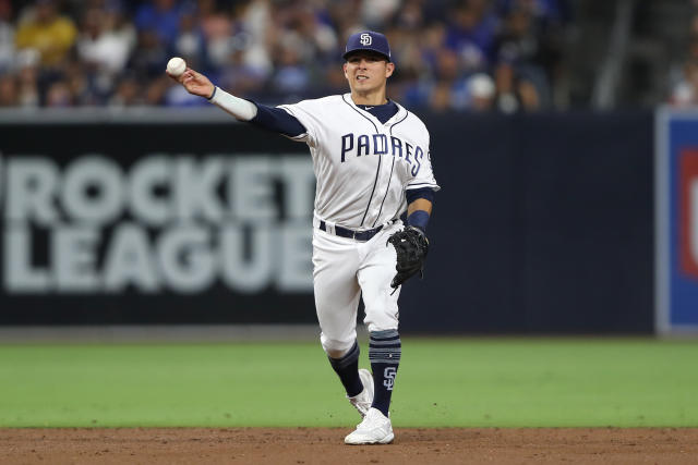 Milwaukee Brewers shortstop Luis Urias throws to first during a