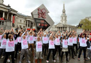 West End theater workers and performers dance in front of the Olympic countdown clock to mark the 100-day countdown, in Trafalgar Square, central London, Wednesday, April 18, 2012. With 100 days to go until the 2012 London Olympics, the city's theater community is increasingly confident that culture won't suffer during a summer devoted to celebrating sport. (AP Photo/PA, John Stillwell) UNITED KINGDOM OUT, NO SALES, NO ARCHIVE