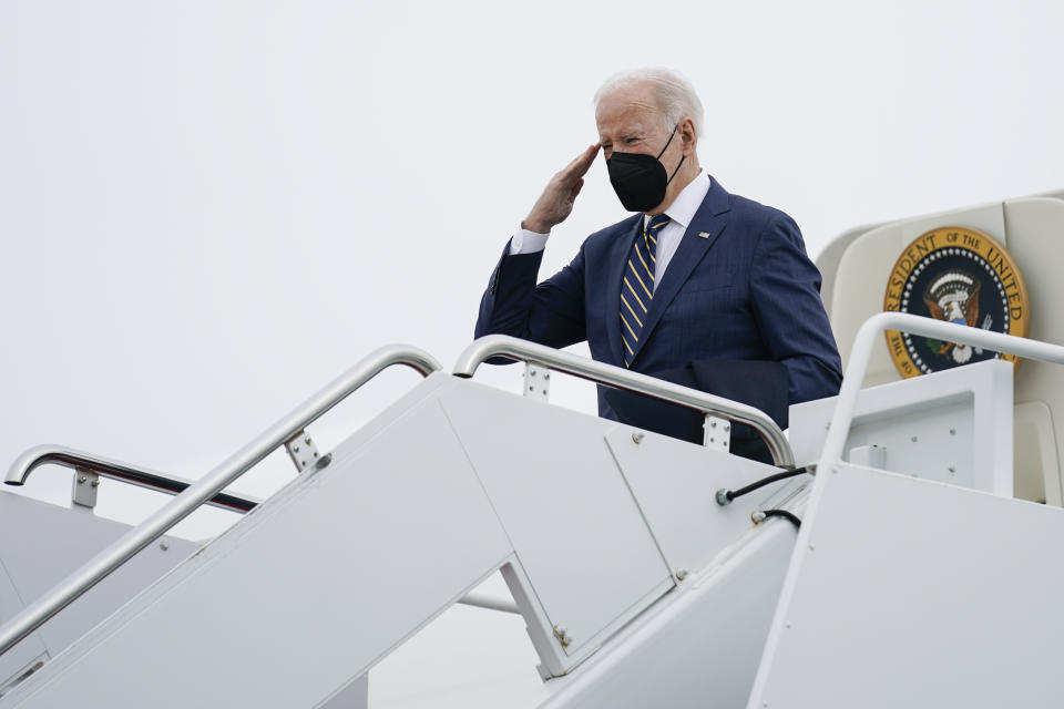 President Joe Biden returns a salute as he boards Air Force One at Andrews Air Force Base, Md., Friday, Jan. 28, 2022. Biden is en route to Pittsburgh. (AP Photo/Andrew Harnik)