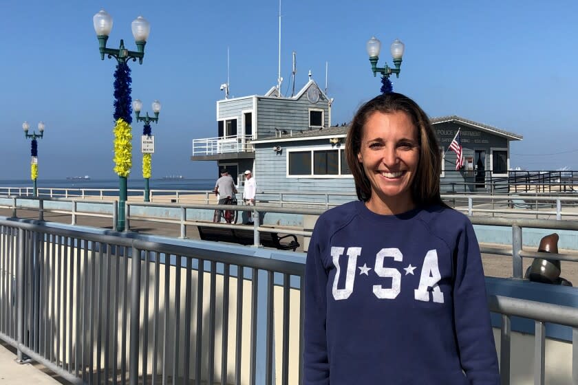 Seal Beach resident Danielle Sams stands in front of the city's pier.