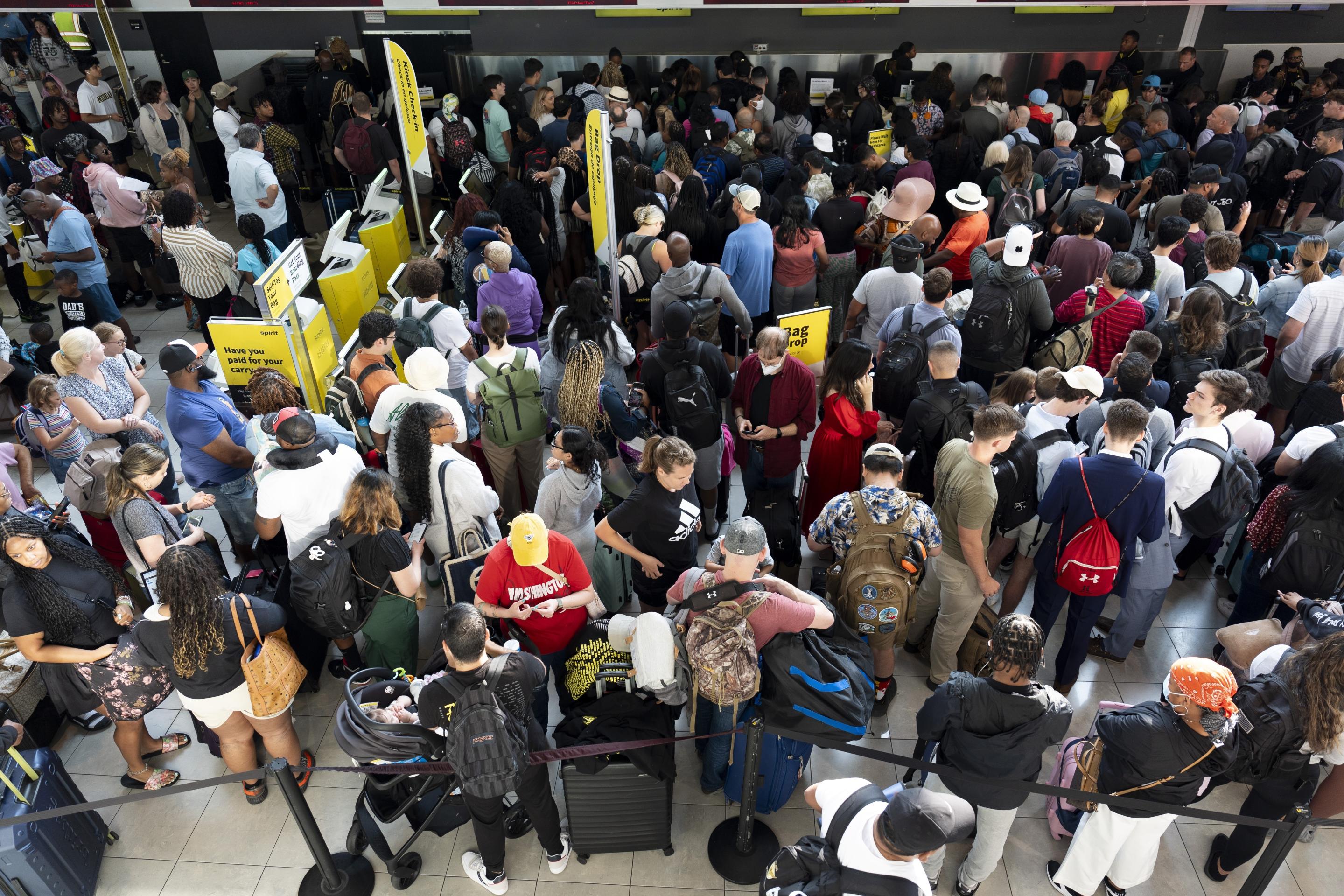 Travelers wait in line at Baltimore/Washington International Thurgood Marshall Airport in Baltimore.