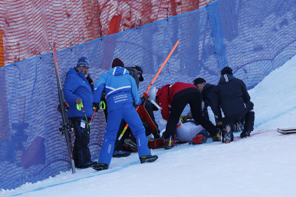 Norway's Aleksander Aamodt Kilde is attended after falling during an alpine ski, men's World Cup downhill race, in Wengen, Switzerland, Saturday, Jan. 13, 2024. (AP Photo/Alessandro Trovati)