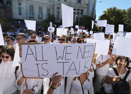 People take part in a demonstration in favour of dialogue to resolve Catalonia´s bid for independence, in Madrid, Spain, October 7, 2017. REUTERS/Sergio Perez